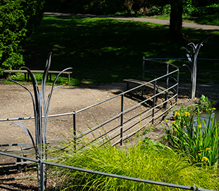 A grass sculpture overlooking a pond