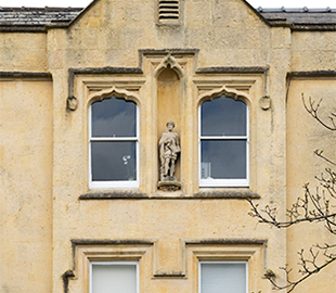 A statue of Hamlet above a Regency Cheltenham building