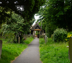 A wooden gate entrance to a graveyard