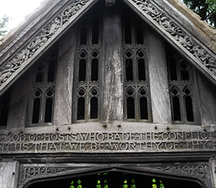 A wooden gate entrance to a graveyard