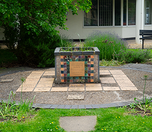 A mosaic planter decorated with ceramic tiles