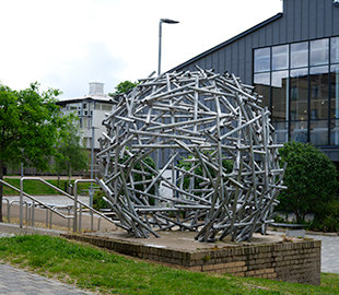 A nest sculpture made with metal pipes