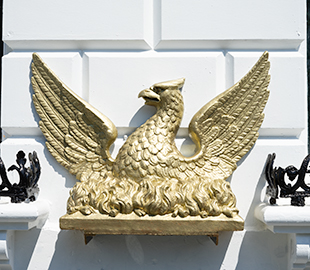 A golden phoenix sculpture in Cheltenham