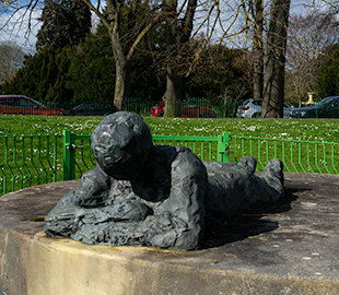 A sculpture of a man lying down