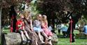 Family sitting in Montpellier Gardens during the Cheltenham Jazz Festival